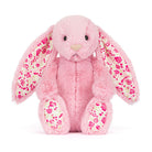 Pink plush bunny with floral patterns on a white background