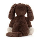 Brown plush dog toy on a white background