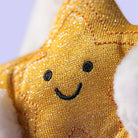 Gold star-shaped plush toy with a smiley face on a white background