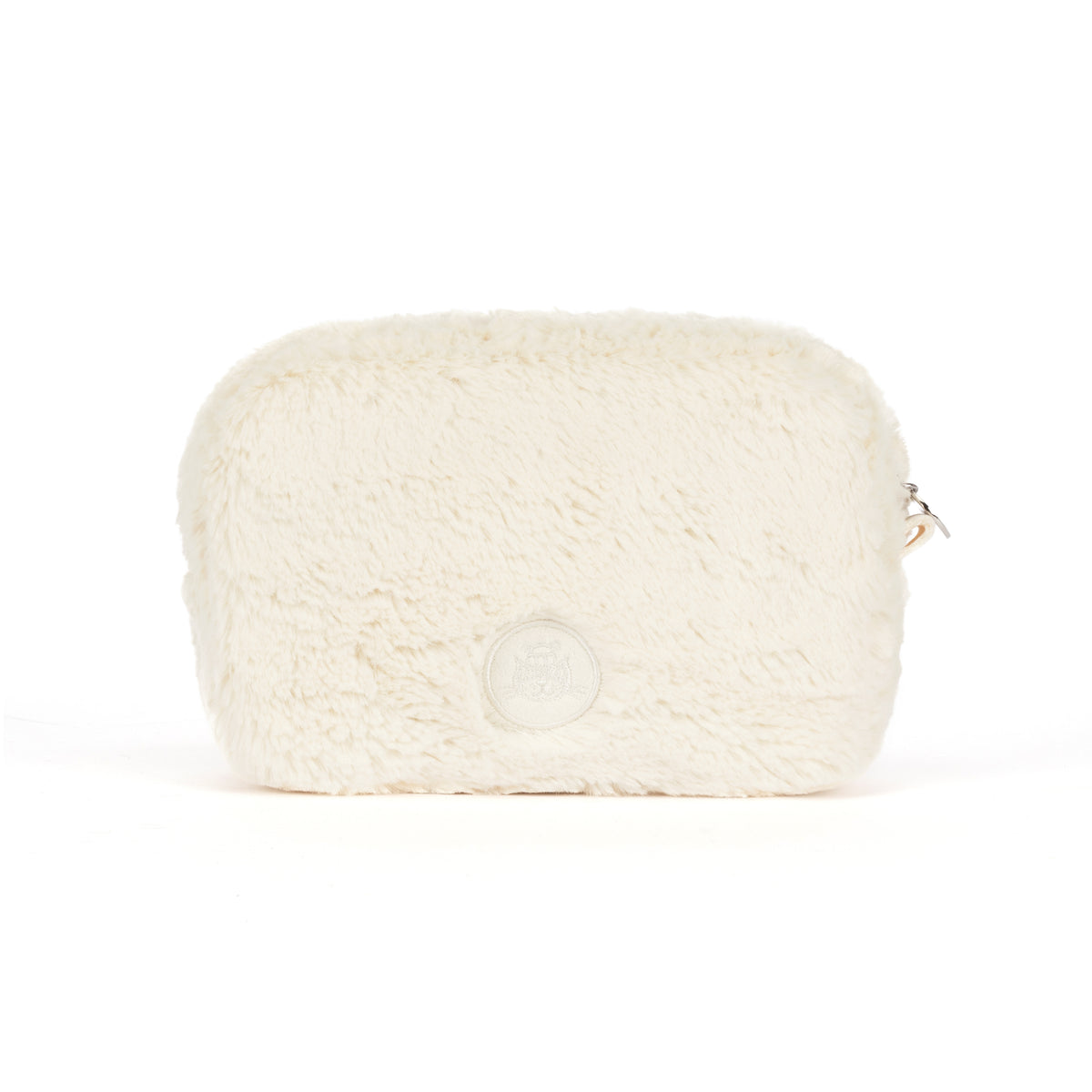 A cream-colored faux fur cosmetic pouch with a small silver zipper pull and a circular embossed logo on the front, set against a plain white background.