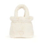 A small plush faux-fur handbag in a warm off-white or cream color, featuring a rounded top handle and a circular button detail on the front, set against a plain white background.