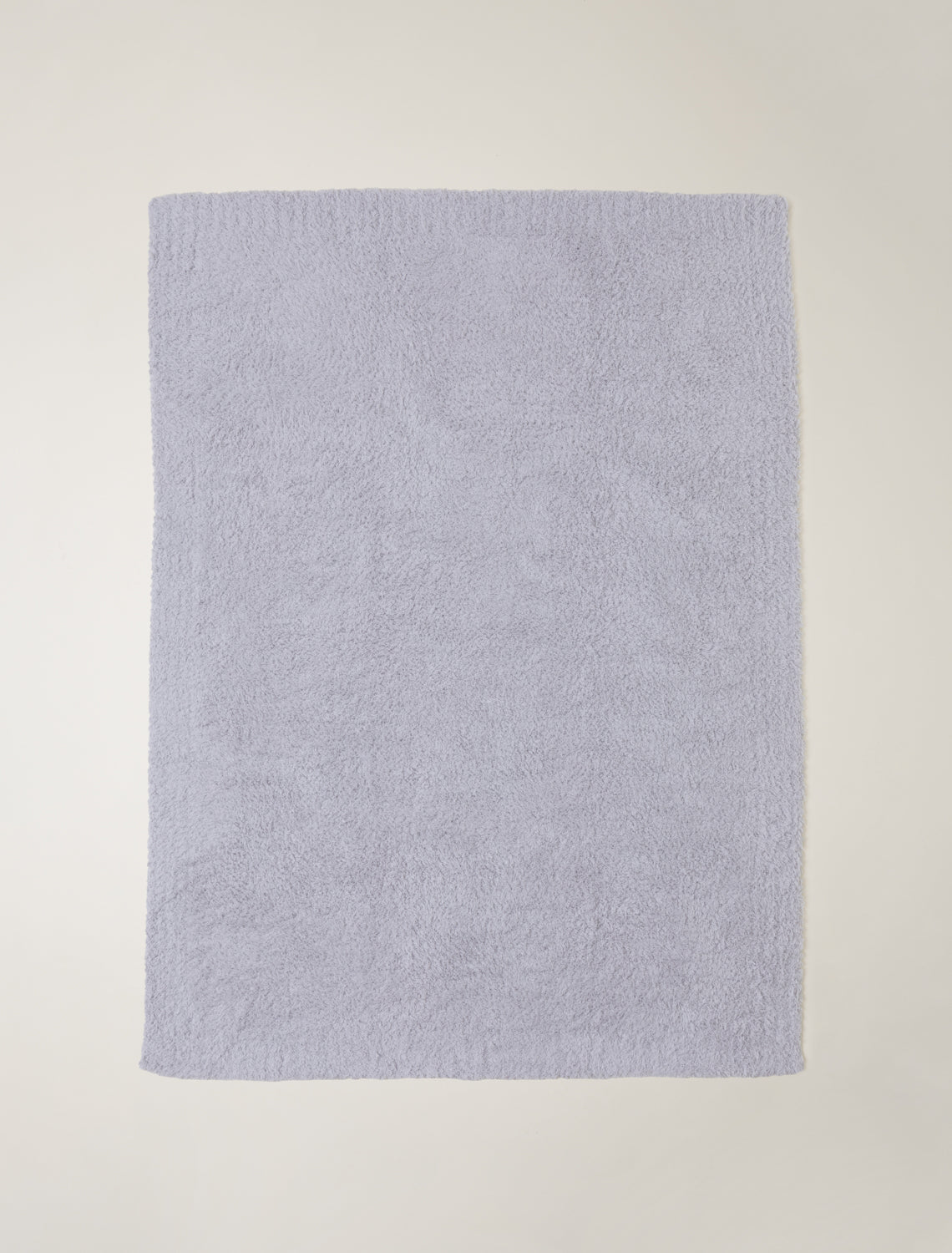 Light blue textured towel on a light gray background