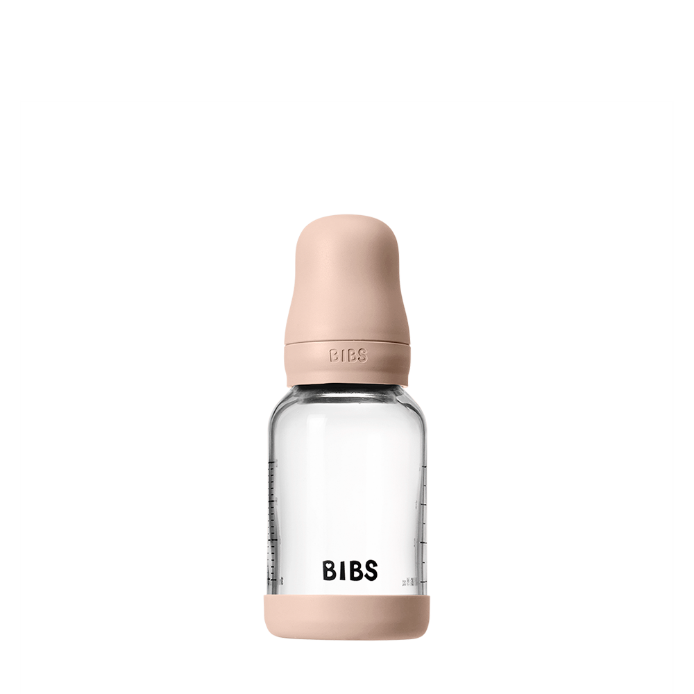 Clear baby bottle with pink cap and 'BIBS' branding on a white background
