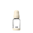 Clear glass baby bottle with beige cap and 'BIBS' branding on a white background