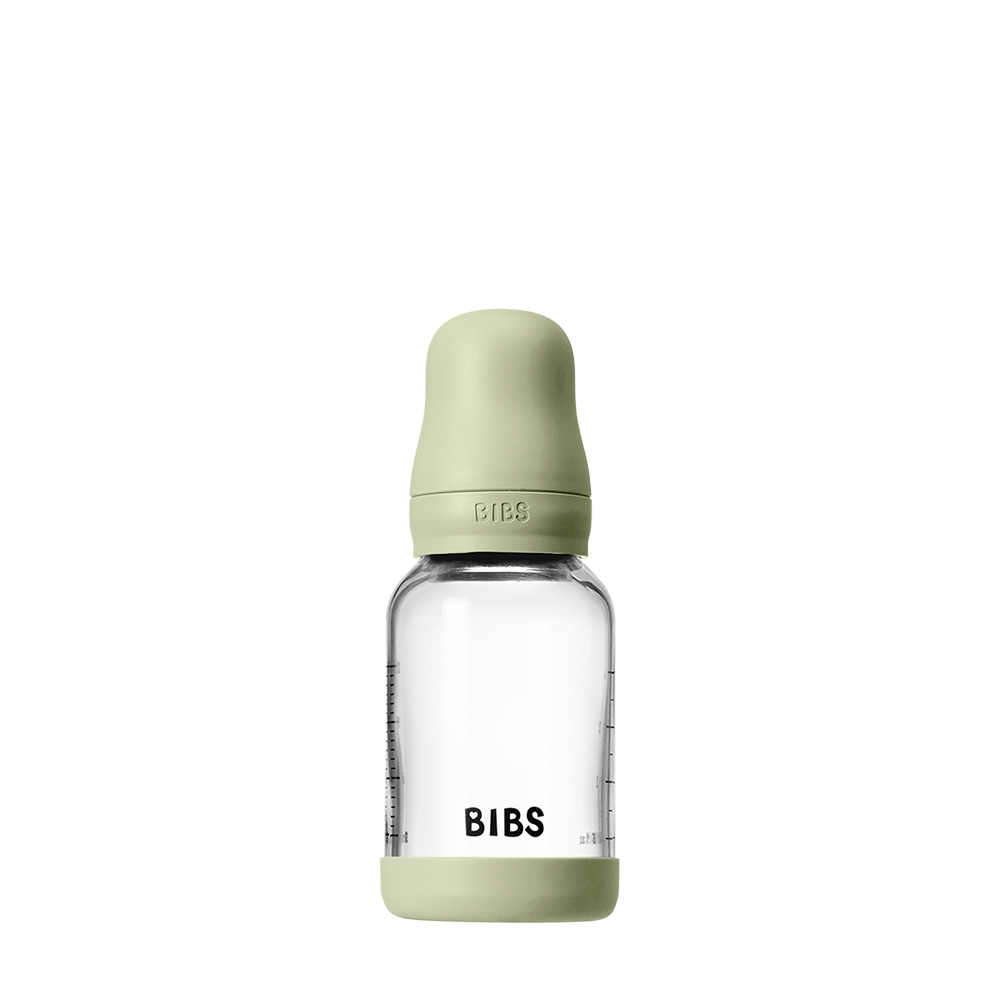Clear baby bottle with green cap and 'BIBS' branding on a white background