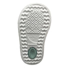 Close-up of a textured shoe sole with brand logo on a white background