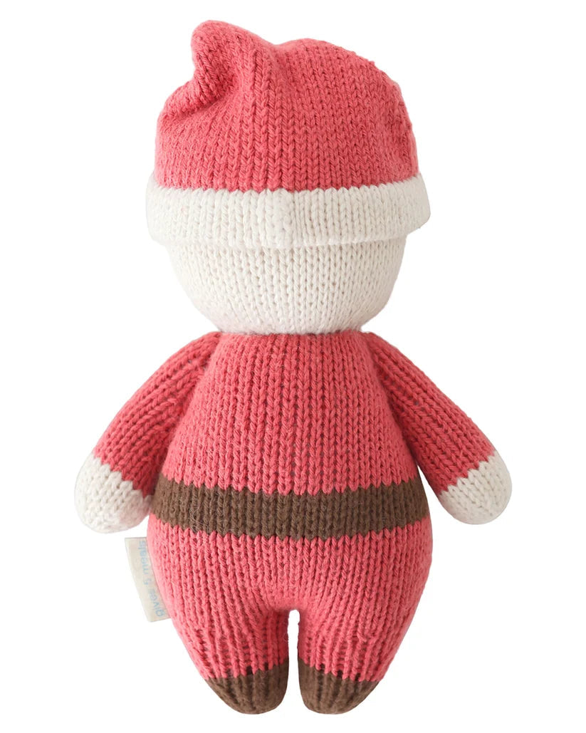 A pink and white knitted plush toy figure with a brown stripe across the torso and brown-tipped feet, shown from the back on a white background.