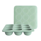 Mint green silicone muffin tray and round mold on a white background