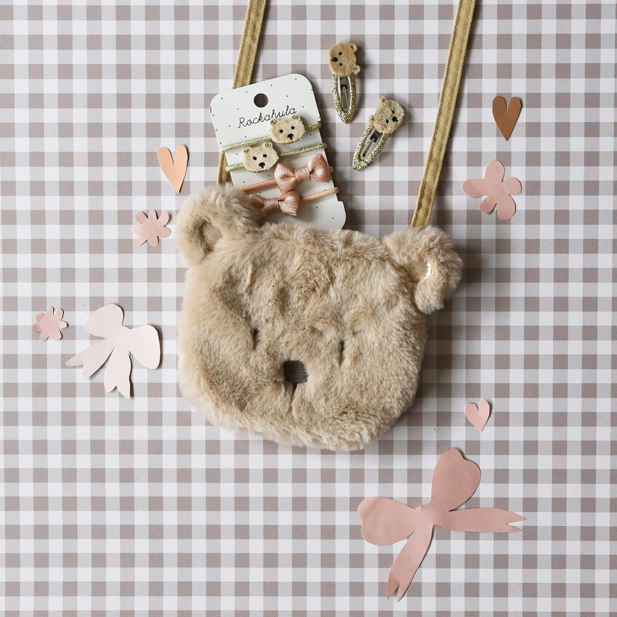 Fluffy bear-shaped bag with decorative elements on a checkered background