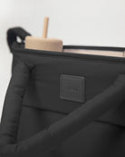 Black bag with a visible brand logo on a white background