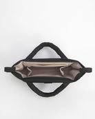 Black bag with beige interior on a white background