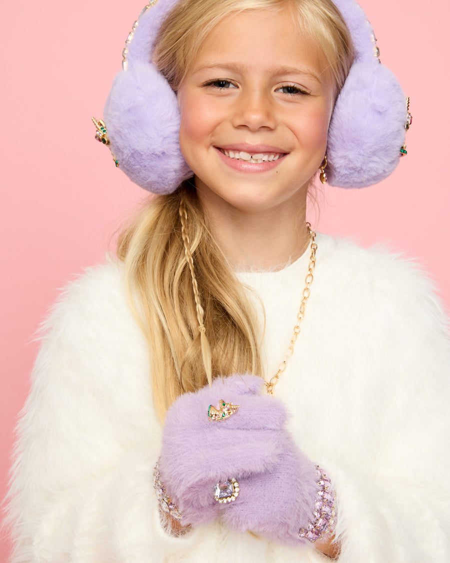 Young girl wearing lavender earmuffs and matching gloves against a pink background