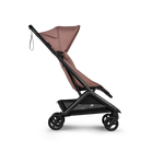 Stroller with pink canopy and black frame on a white background