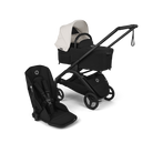 A stroller travel system set against a solid black background, featuring a black stroller with a white canopy, a matching black bassinet seat, and a black infant car seat.