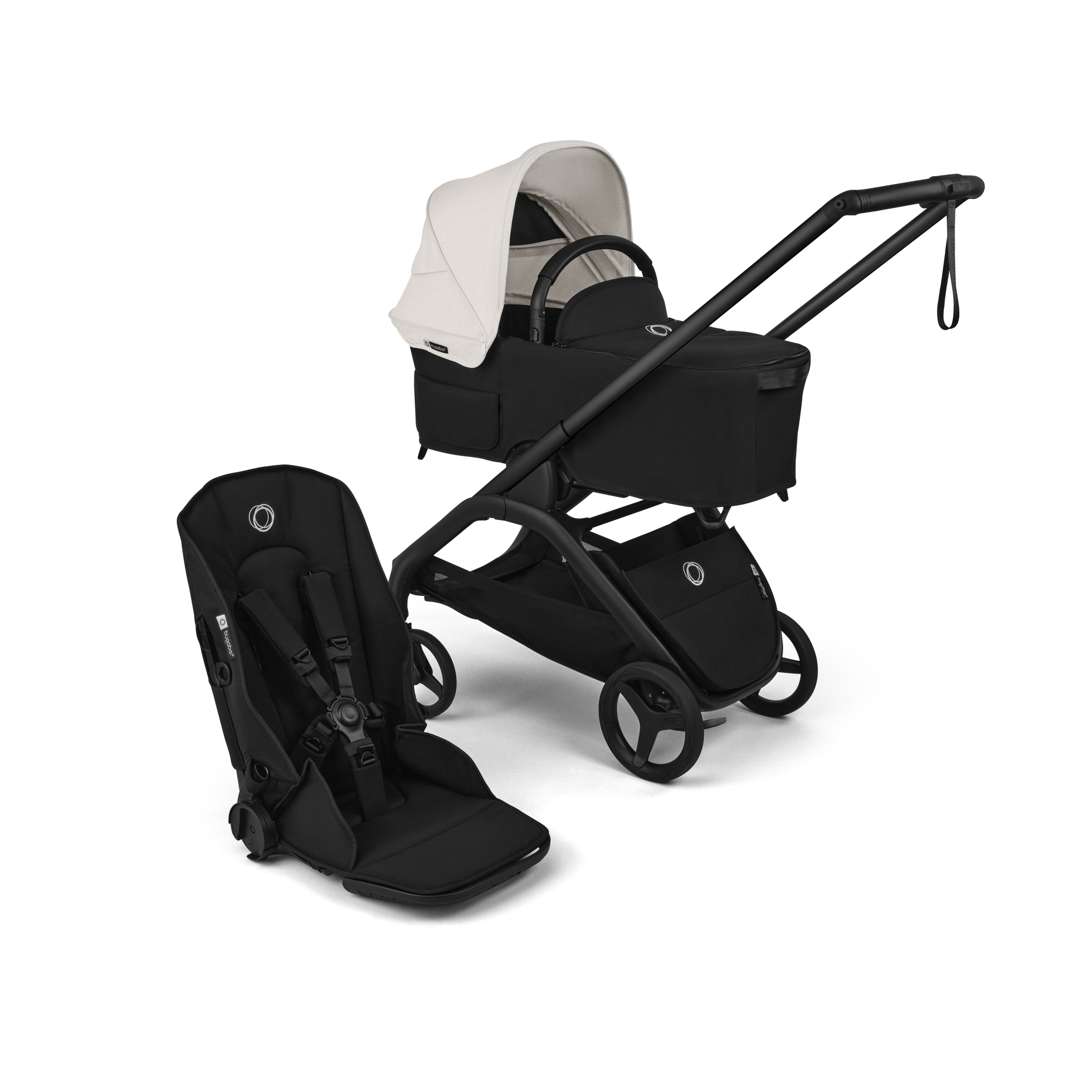 A stroller travel system set against a solid black background, featuring a black stroller with a white canopy, a matching black bassinet seat, and a black infant car seat.