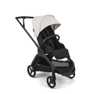 A modern stroller with a black frame and seat, featuring a light beige canopy and black wheels, shown on a clean white background.