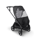 A black stroller with a matching black rain cover and a gray sun shield, shown from a three-quarters angle on a white background.