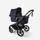Navy blue stroller with black wheels on a white background