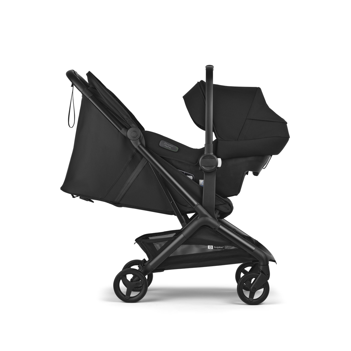 A black stroller and bassinet travel system shown from a side profile view against a solid white background. The stroller features a black fabric liner, a dark gray frame, and black wheels, with a matching black bassinet attached.