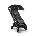 A stroller with a black canopy umbrella attached, shown on a clean white background. The stroller features a dark gray and black frame with a gray seat cushion, and the umbrella is black with a small white circular logo.