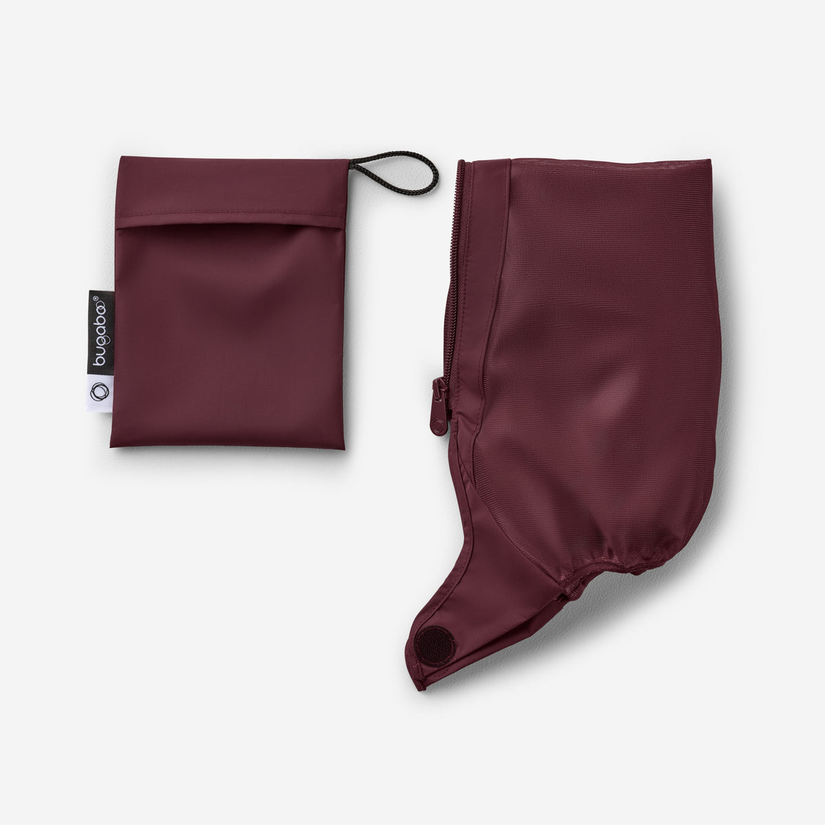 Maroon rain poncho and pouch on a light gray background