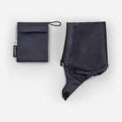 Black rain poncho and pouch on a white background