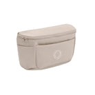A light beige waist bag with a zippered top and a front pocket featuring a circular logo, shown on a plain white background.