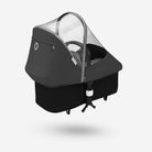 Black baby stroller with canopy on a white background