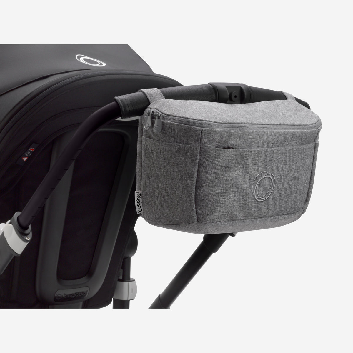 Gray storage basket attached to a black stroller on a white background