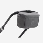 Gray stroller organizer attached to a stroller on a white background