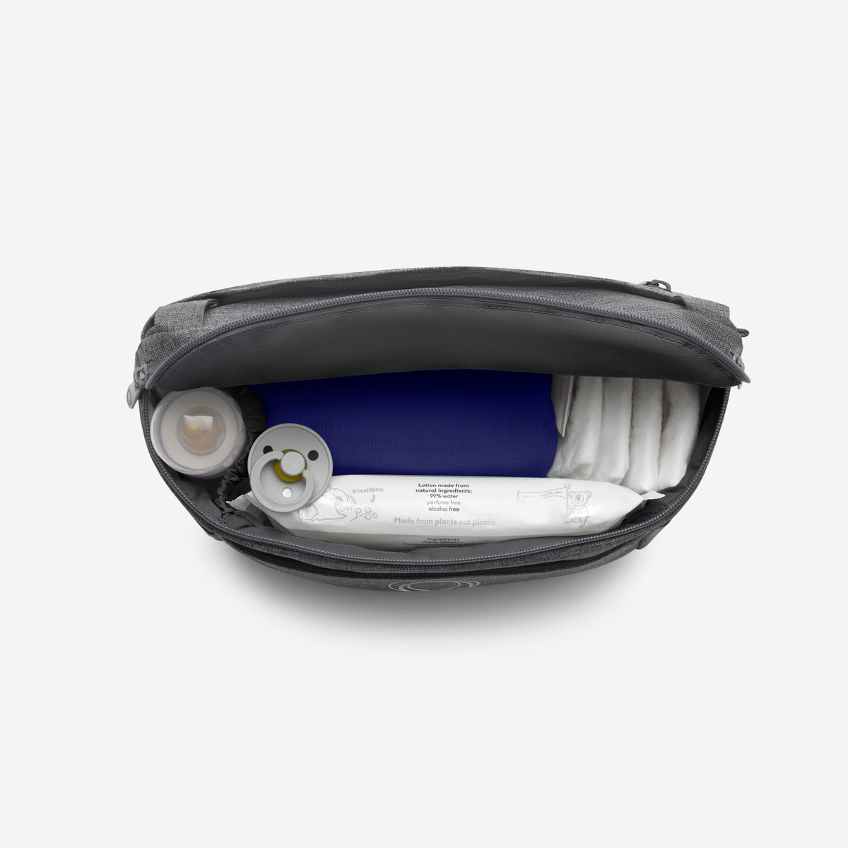 Black diaper bag with baby items including a blue diaper and white wipes on a white background