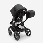 Black stroller with a black organizer and with a baby seat on a white background