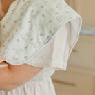 Baby diaper with animal pattern held by a person, brand 'Cotswold Baby' visible