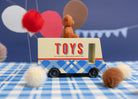 Toy truck with 'TOYS' on a blue checkered tablecloth