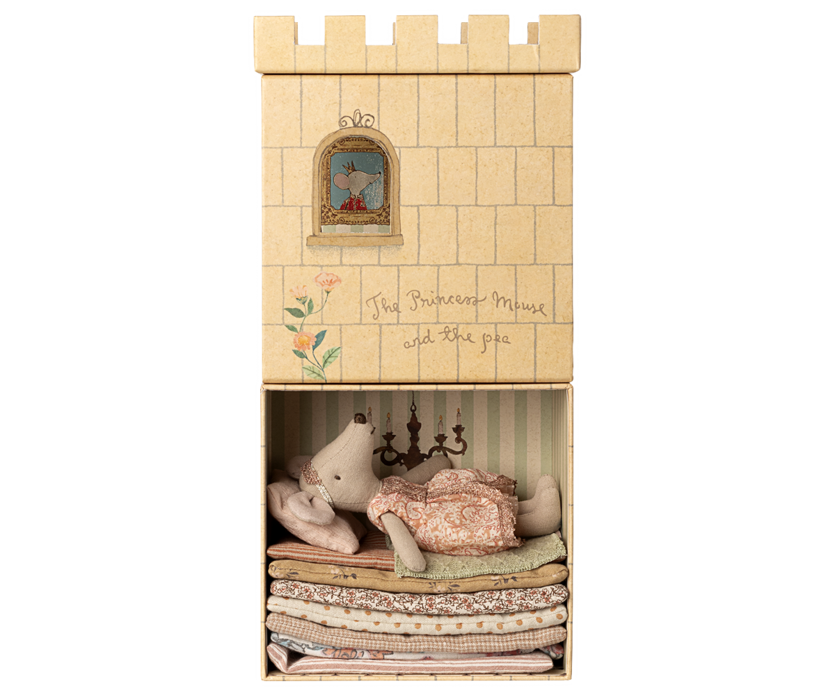 A Maileg toy set featuring an illustrated castle box with a lower compartment that opens to reveal a Big Sister mouse resting atop a tall stack of colorful layered mattresses.