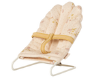 A miniature off-white Maileg micro babysitter bouncy chair with a soft floral patterned fabric seat and a metal wire frame, shown against a transparent checkered background.