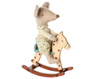 Stuffed mouse toy in pajamas riding a wooden rocking horse on a white background