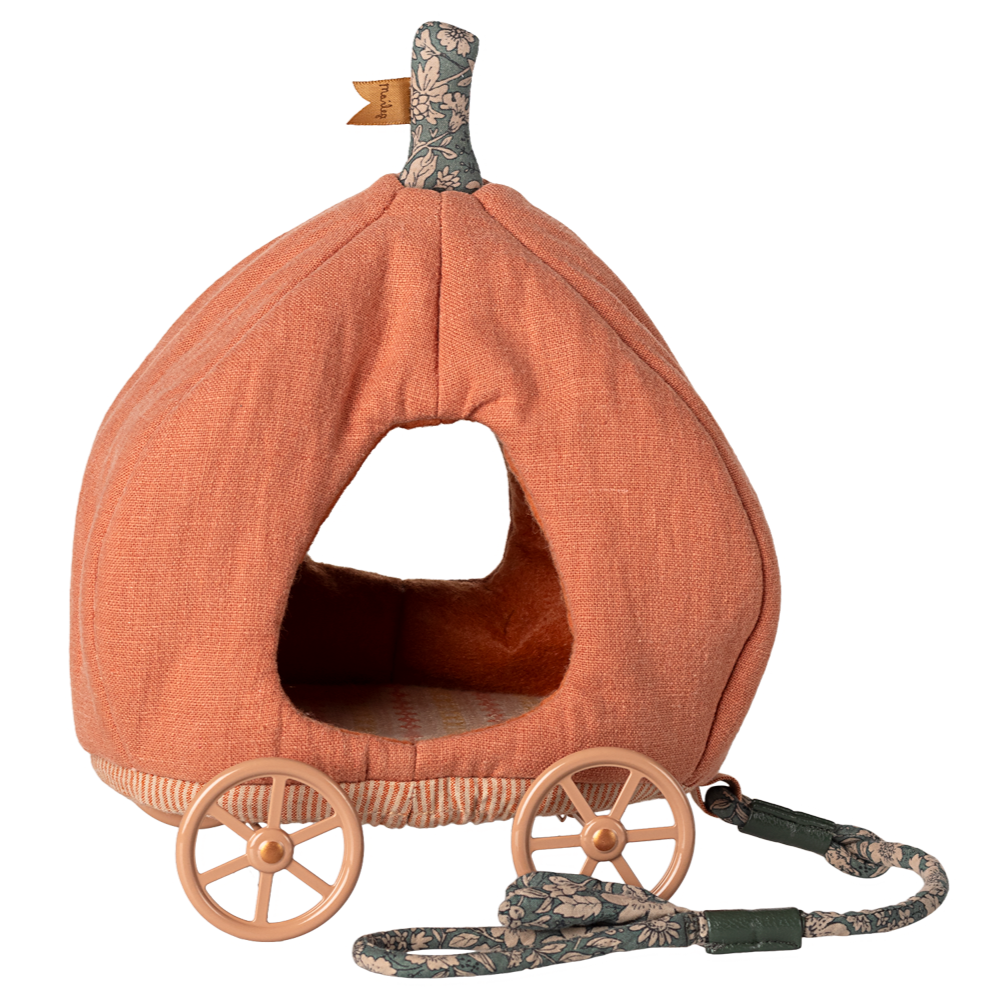 Pumpkin-shaped pet bed with wheels and a leash on a white background