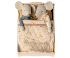 Two plush mice toys in a wooden box with a quilted lid featuring floral patterns.