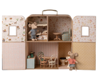 Miniature dollhouse with furniture and toy mice inside a suitcase