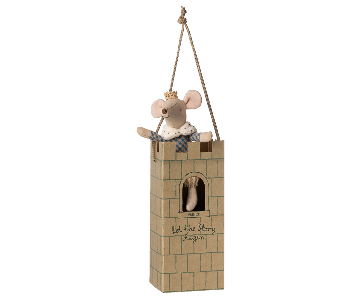 Stuffed mouse in a small castle toy on a white background