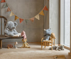 Children's room with plush toys and a colorful banner on a wall.