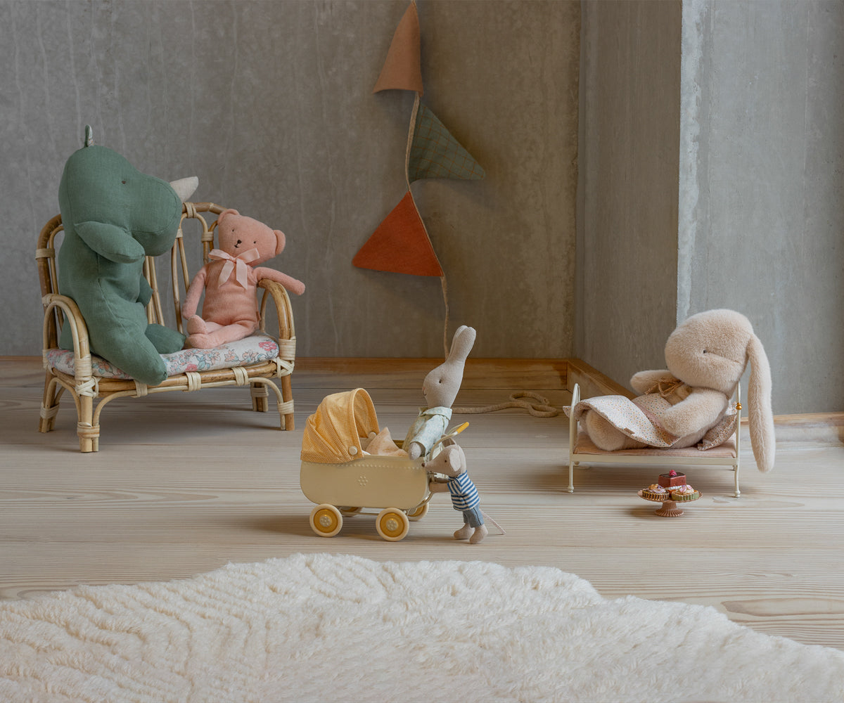 Miniature scene with stuffed animals in a room setting