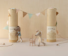 Two toy mice with decorative boxes and a banner on a neutral background