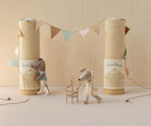 Two toy mice with decorative boxes and a small chair on a neutral background