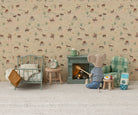 Two Maileg mouse toys in a miniature room setting with patterned wallpaper and carpet; one mouse on the left operates a toy vacuum cleaner next to a thermos and canister, while another mouse on the right stands beside a mint green single bed and a matching storage cabinet with a blue lantern on top.