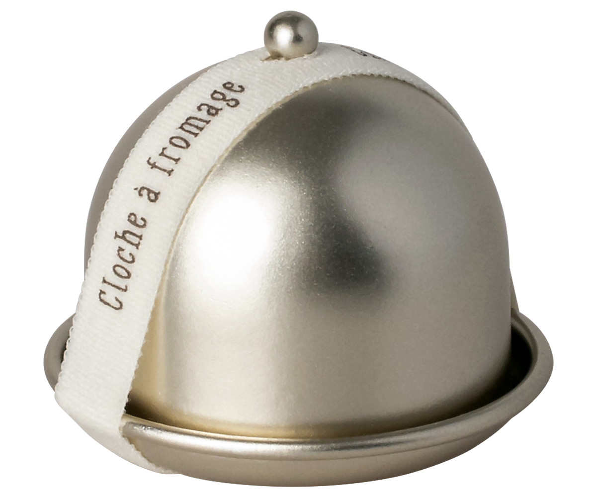 Metallic cheese dome with a white label on a white background