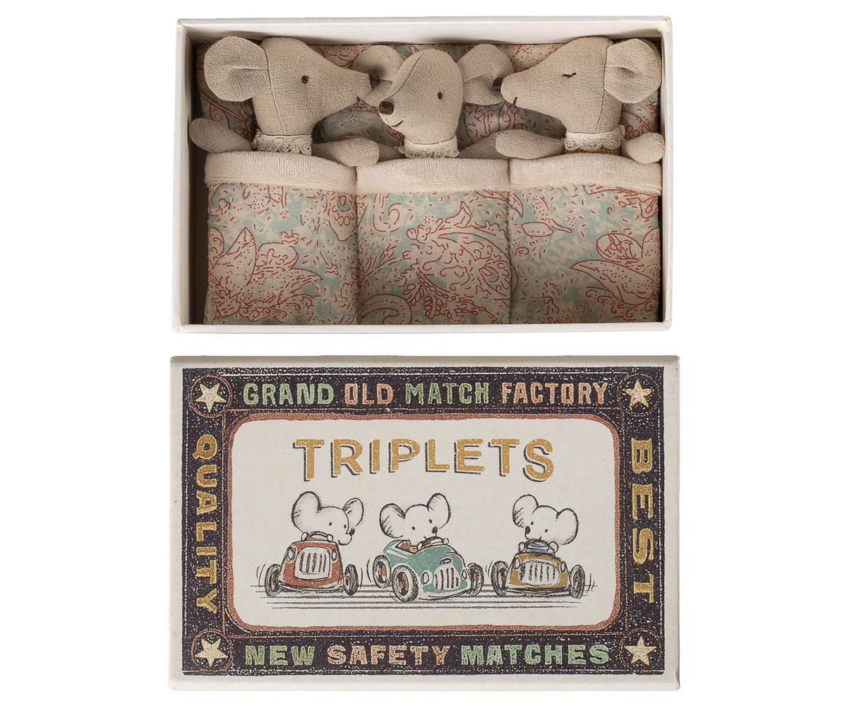 Matchbox with toy mice and decorative label on a white background