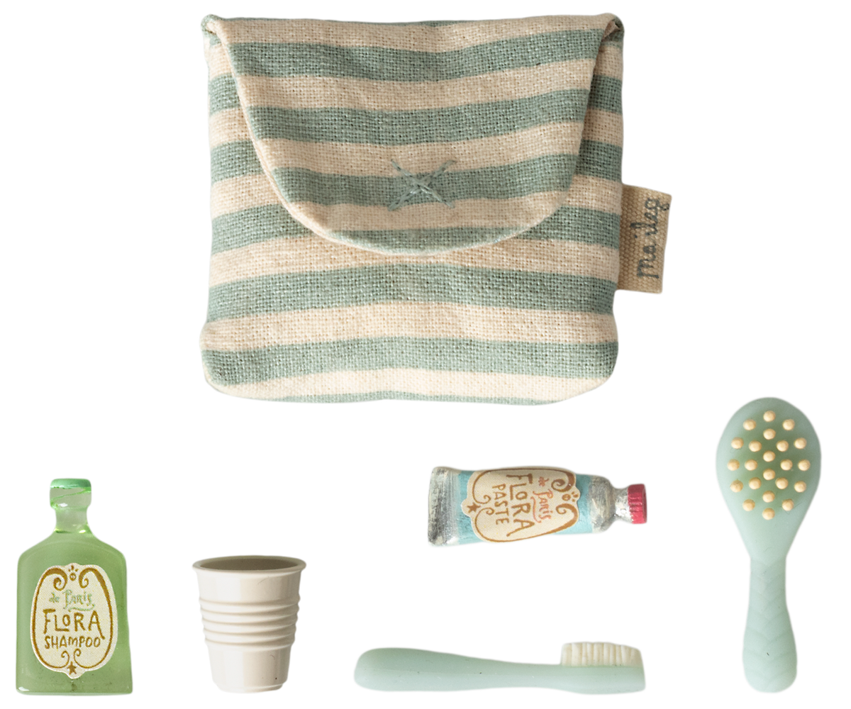 Set of baby care products including a striped pouch, bottle, cup, tube, and brush on a white background.