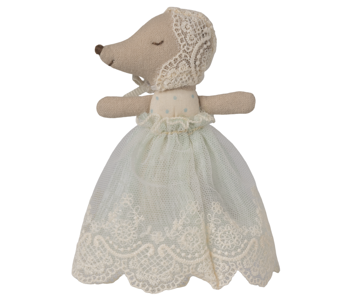 Stuffed animal toy with a lace dress on a white background